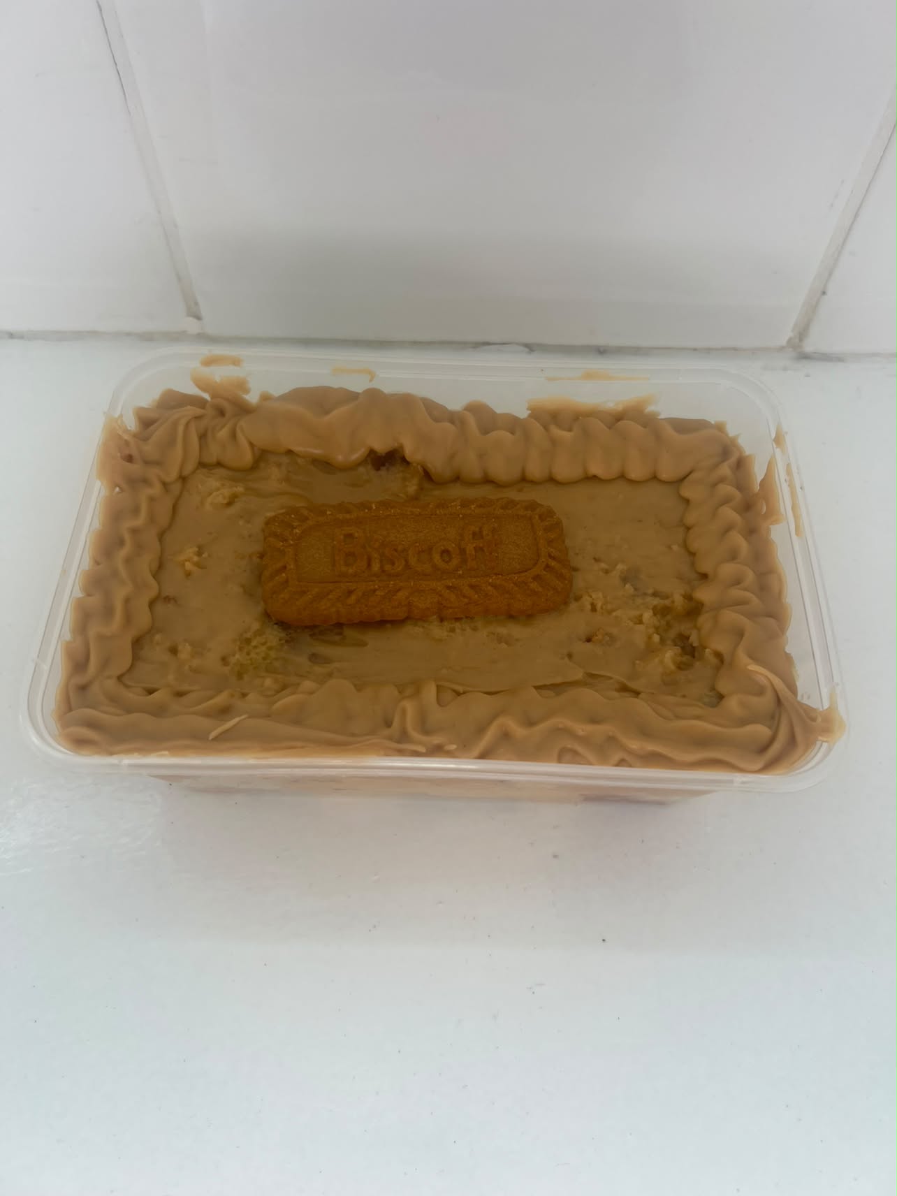 Biscoff cake tub by Bella & Bloom Co. topped with smooth Biscoff icing and a Biscoff biscuit