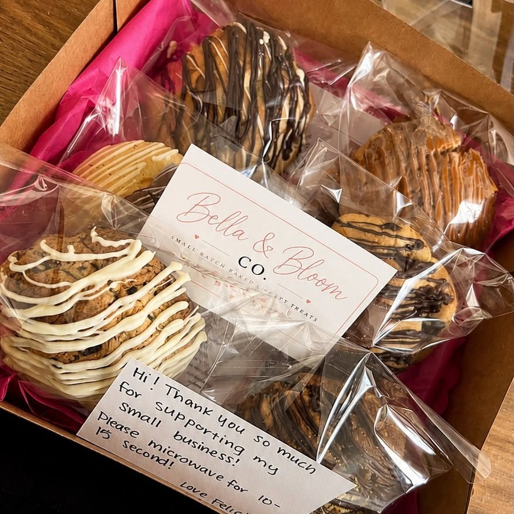 Bella and Bloom Co. gift box packed with individually wrapped drizzled cookies