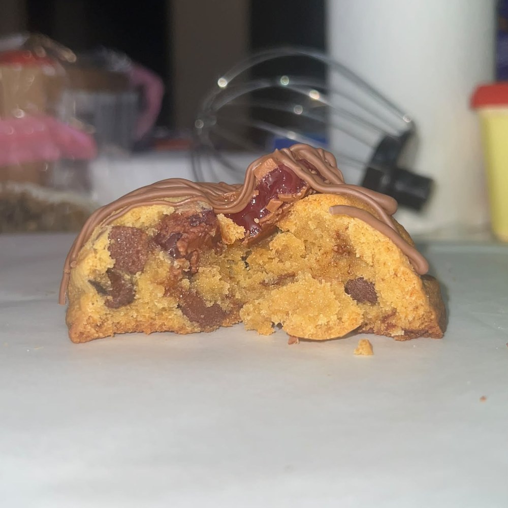 Cookie cut in half showing chocolate chunks and a Turkish delight filling